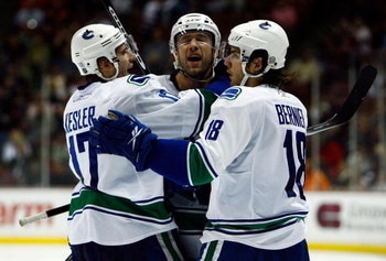 ANAHEIM, CA - OCTOBER 31:  (L-R) Ryan Kesler #17, Mattias Ohlund #2, and Steve Bernier #18 of the Vancouver Canucks celebrate Ohlund's goal in the second period against the Anaheim Ducks looks at the Honda Center on October 31, 2008 in Anaheim, California