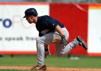 SARASOTA, FL - MARCH 1:  Outfielder Brett Gardner #11 of the New York Yankees over runs second base against the Cincinnati Reds March 1, 2009 at Ed Smith Stadium in Sarasota, Florida.  Gardner was tagged out.  (Photo by Al Messerschmidt/Getty Images)