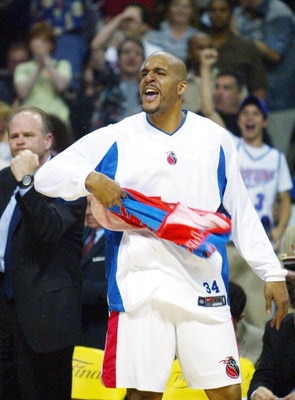 AUBURN HILLS, MI - JUNE 13:  Corliss Williamson #34 of the Detroit Pistons celebrates on the bench during the second quarter in game four of the 2004 NBA Finals against the Los Angeles Lakers on June 13, 2004 at The Palace of Auburn Hills in Auburn Hills,