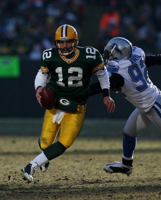 GREEN BAY, WI - DECEMBER 28: Aaron Rodgers #12 of the Green Bay Packers breaks away from Cliff Avril #92 of the Detroit Lions on December 28, 2008 at Lambeau Field in Green Bay, Wisconsin. The Packers defeated the Lions 31-21. (Photo by Jonathan Daniel/Ge