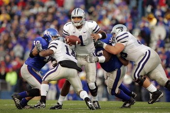 LAWRENCE, KS - NOVEMBER 18:  Quarterback Josh Freeman #1 of the Kansas State Wildcats gets caught in the rush by defensive lineman James McClinton #93 of the Kansas Jayhawks at Memorial Stadium November 18, 2006 in Lawrence, Kansas. The Kansas Jayhawks wo