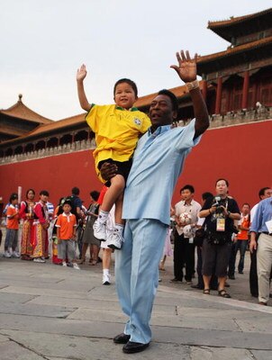 BEIJING - AUGUST 23:  Brazilian football legend Edson Arantes do Nacimento, known as Pele, holds nine-year-old Sichuan province earthquake youth survivor Lin Hao as he meets Sichuan province earthquake youth survivors in front of the Forbidden City on Aug