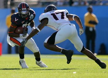 JACKSONVILLE, FL - JANUARY 01:  Jameel Sewel #10 of the Virginia Cavaliers is cornered by Chris Parker #17 of the Texas Tech Red Raiders during the Gator Bowl at Jacksonville Municipal Stadium on January 1, 2008 in Jacksonville, Florida.  (Photo by Sam Gr