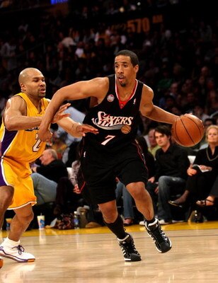 LOS ANGELES - MARCH 17:   Andre Miller #7 of the Philadelphia 76ers drives around Derek Fisher #3 of the Los Angeles Lakers on March 17, 2009 at Staples Center in Los Angeles, California.  The 76ers won 94-93.   NOTE TO USER: User expressly acknowledges a