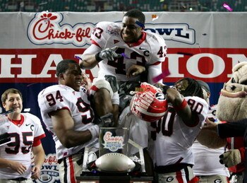 ATLANTA - DECEMBER 30:  Tony Taylor #43 of the Georgia Bulldogs is held up by teammates Quentin Moses #94 and Mario Raley #80 after winning the Defensive Player MVP award against the Virginia Tech Hokies during the Chick-fil-a Bowl on December 30, 2006 at