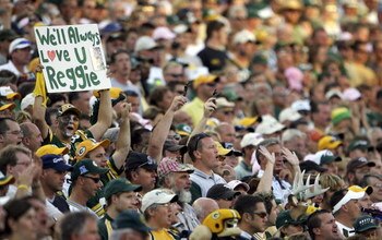 GREEN BAY, WI - SEPTEMBER 18:  A fan of the Green Bay Packers holds up a sign honoring the late Reggie White, whose number '92' was retired during a half time ceremony, in a game against the Cleveland Browns at Lambeau Field September 18, 2005 in Green Ba