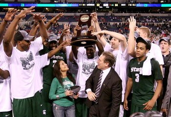 INDIANAPOLIS - MARCH 29:  Head coach Tom Izzo of the Michigan State Spartans and his wife, Lupe, celebrate with the Michigan State players after they were presented with the midwest region trophy following their 64-52 win against the Louisville Cardinals 