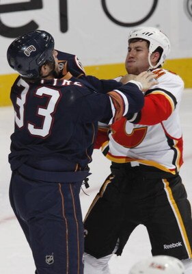 EDMONTON, CANADA - October 18: Brandon Prust #29 of the Calgary Flames and Steve MacIntyre #33 of the Edmonton Oilers get into an altercation during their NHL game on October 18, 2008 at Rexall Place in Edmonton, Alberta, Canada. (Photo by Dale MacMillan/