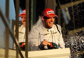 MELBOURNE, AUSTRALIA - MARCH 29:  Jenson Button of Great Britain and Brawn GP celebrates on the podium as he wins the Australian Formula One Grand Prix at the Albert Park Circuit on March 29, 2009 in Melbourne, Australia.  (Photo by Robert Cianflone/Getty