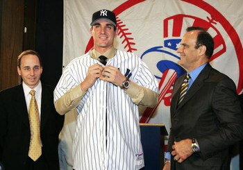 NEW YORK - DECEMBER 22:  (L to R) New York Yankees general manger Brian Cashman  with Carl Pavano and manger Joe Torre at a press conference where the Yankees announced that they have signed free-agent right-handed pitcher Carl Pavano to a four-year contr