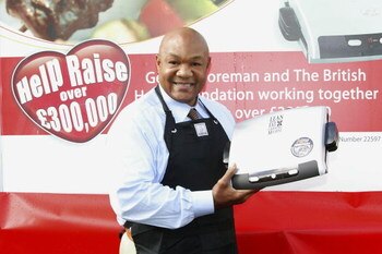 LONDON, UNITED KINGDOM - OCTOBER 20:  Former world heavyweight boxing champion George Foreman poses with his trademark grill on October 20, 2006 in London, England. He is in London to celebrate the tenth anniversary of his iconic brand and to officially l
