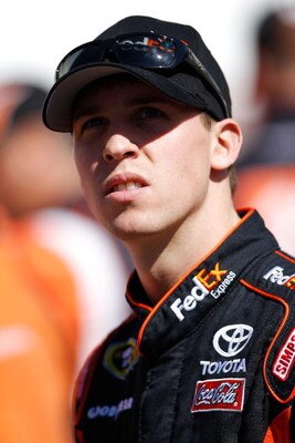 BRISTOL, TN - MARCH 20:  Denny Hamlin, driver of the #11 FedEx Toyota  stands by his car during qualifying for the NASCAR Sprint Cup Series Food City 500 at Bristol Motor Speedway on March 20, 2009 in Bristol, Tennessee.  (Photo by Chris Graythen/Getty Im