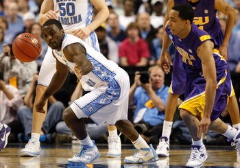 GREENSBORO, NC - MARCH 21:  Ty Lawson #5 of the North Carolina Tar Heels reaches back for a loose ball against Bo Spencer #11 of the Louisiana State University Tigers during the second round of the NCAA Division I Men's Basketball Tournament at the Greens