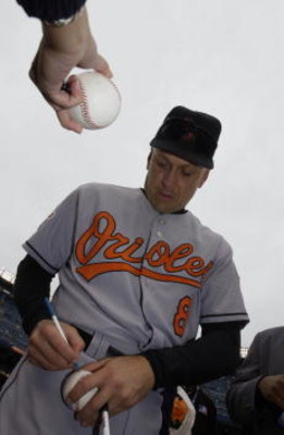 30 Sep 2001: Cal Ripken Jr. of the Baltimore Orioles signs autographs before his final game against the New York Yankees at Yankee Stadium in the Bronx, New York. DIGITAL IMAGE. Mandatory Credit: Ezra Shaw/Allsport