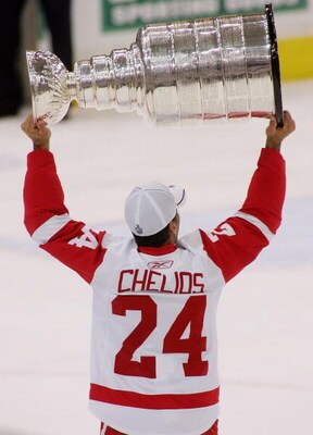 PITTSBURGH - JUNE 04:  Chris Chelios #24 of the Detroit Red Wings celebrates with the Stanley Cup after defeating the Pittsburgh Penguins in game six of the 2008 NHL Stanley Cup Finals at Mellon Arena on June 4, 2008 in Pittsburgh. Pennsylvania. The Red W