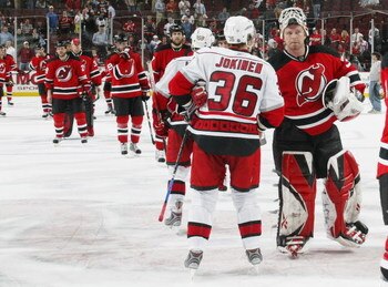 NEWARK, NJ - APRIL 28:  Jussi Jokinen #36 of the Carolina Hurricanes is congratulated by Martin Brodeur #30 of the New Jersey Devils after the Hurricanes defeats the Devils 4-3 in Game Seven of the Eastern Conference Quarterfinal Round of the 2009 Stanley