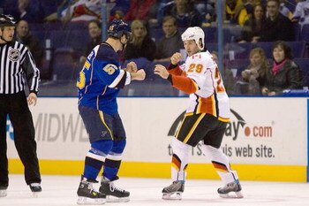 ST. LOUIS, MO. - DECEMBER 5:  Brandon Prust #29 of the Calgary Flames looks to fight with Cam Janssen #55 of the St. Louis Blues at the Scottrade Center on December 5, 2008 in St. Louis, Missouri.  The Flames beat the Blues 4-3 in overtime.  (Dilip Vishwa