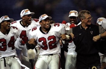 17 Jan 1999:  Jamal Anderson #32 of the Atlanta Falcons dances the dirty bird with coach Dan Reeves during the NFC Championship Game against the Minnesota Vikings at the H. H. H. Metrodome in Minneapolis, Minnesota. The Falcons defeated the Vikings 30-27.