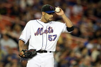 NEW YORK - SEPTEMBER 23:  Johan Santana #57 of the New York Mets adjusts his hat after the third inning against the Chicago Cubs during their game at Shea Stadium September 23, 2008 in the Flushing neighborhood of the Queens borough of New York City.  (Ph