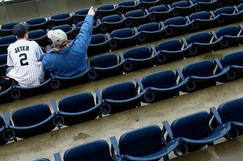 NEW YORK - APRIL 03: Spectators wait for the game to between the New York Yankees of the Chicago Cubs to start on April 3, 2009 at Yankee Stadium in the Bronx borough of New York City. The exhibition game is the first game to be played at the New Yankee S