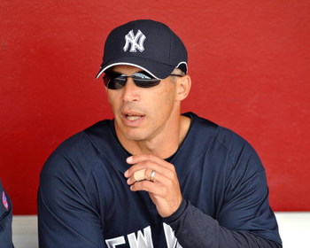 SARASOTA, FL - MARCH 1:  Manager Joe Girardi #27 of the New York Yankees watches warm ups against the Cincinnati Reds March 1, 2009 at Ed Smith Stadium in Sarasota, Florida.  (Photo by Al Messerschmidt/Getty Images)