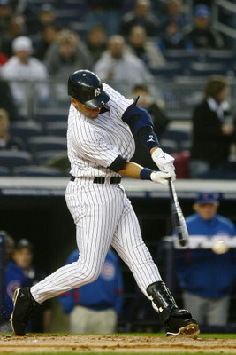NEW YORK - APRIL 03: Derek Jeter #2 of the New York Yankees swings at a pitch against the Chicago Cubs during their game on April 3, 2009 at Yankee Stadium in the Bronx borough of New York City. The exhibition game is the first game to be played at the ne