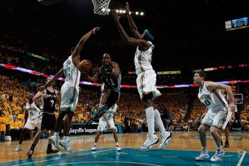 NEW ORLEANS - MAY 13:  Jacque Vaughn #11 of the San Antonio Spurs makes a shot around Julian Wright #32 of the New Orleans Hornets in Game Five of the Western Conference Semifinals during the 2008 NBA Playoffs at The New Orleans Arena on May 13, 2008 in N