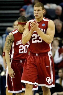 MEMPHIS, TN - MARCH 29:  Blake Griffin #23 of the Oklahoma Sooners claps as he stands in front of teammate Austin Johnson #20 in the first half while taking on the North Carolina Tar Heels during the NCAA Men's Basketball Tournament South Regional Final a