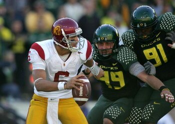 EUGENE, OR - OCTOBER 27:  Quarterback Mark Sanchez #6 of the Southern California Trojans is pressured by Nick Reed #49 and Ra'Shon Harris #91 of the Oregon Ducks at Autzen Stadium October 27, 2007 in Eugene, Oregon.  (Photo by Jonathan Ferrey/Getty Images