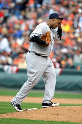 BALTIMORE - APRIL 06:  C.C. Sabathia #52 of the New York Yankees wipes his head after giving up three runs in the third inning against the Baltimore Orioles during opening day on April 6, 2009 at Camden Yards in Baltimore, Maryland.  (Photo by Greg Fiume/