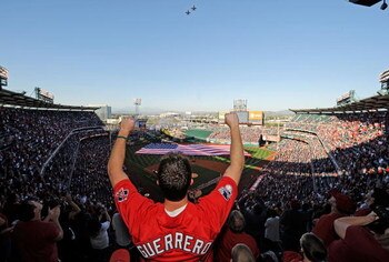 ANAHEIM, CA - APRIL 06:  A fan celebrates after the national anthem during Los Angeles Angels opening day ceremonies against the Oakland Athletics at the Angels Stadium of Anaheim on April 6, 2009 in Anaheim, California.  (Photo by Kevork Djansezian/Getty