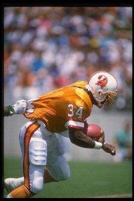 4 Sep 1988:  Running back Lars Tate of the Tampa Bay Buccaneers attempts to break the tackle of a Philadelphia Eagles player during a game at Veterans Stadium in Philadelphia, Pennsylvania.  The Eagles won the game, 41-14. Mandatory Credit: Allen Dean Ste