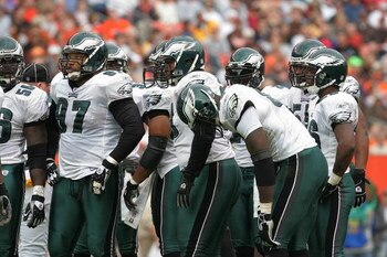 CLEVELAND - OCTOBER 24:  The Philadelphia Eagles defensive unit talks with head coach Andy Reid during the game with the Cleveland Browns on October 24, 2004 at Cleveland Browns Stadium in Cleveland, Ohio. The Eagles defeated the Browns 34-31 in overtime.