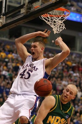 MINNEAPOLIS - MARCH 20:  Cole Aldrich #45 of the Kansas Jayhawks reacts after he dunked the ball over Michael Tveidt #23 (R) of the North Dakota State Bison during the first round of the NCAA Division I Men's Basketball Tournament at the Hubert H. Humphre