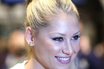 NEW YORK - MARCH 25:  Professional tennis player and model Anna Kournikova poses for a photograph at the New York Stock Exchange opening bell on March 25, 2009 in New York City.  (Photo by Neilson Barnard/Getty Images)