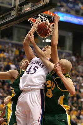 MINNEAPOLIS - MARCH 20:  Cole Aldrich #45 of the Kansas Jayhawks dunks against Michael Tveidt (R) #23 and Brett Winkelman #22 the North Dakota State Bison in the second half during the first round of the NCAA Division I Men's Basketball Tournament at the 