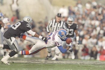 24 Dec 1995:  Wide receiver Mike Pritchard of the Denver Broncos dives for the ball as cornerback Bruce Pickens of the Oakland Raiders tries to tackle him at the Oakland Coliseum in Oakland, California.  The Broncos won the game 31-28. Mandatory Credit: J