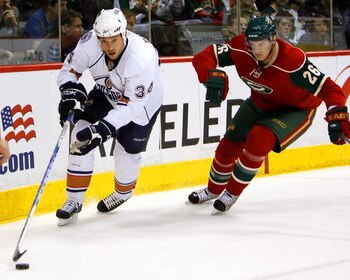 ST. PAUL, MN - MARCH 22:  Kurtis Foster #26 of the Minnesota Wild tries to catch Fernando Pisani #34 of the Edmonton Oilers March 22, 2009 at the Xcel Energy Center in St. Paul, Minnesota. Minnesota won, 3-0. (Photo by Scott A. Schneider/Getty Images)