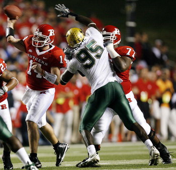 PISCATAWAY, NJ - OCTOBER 18: Quarterback Mike Teel #14 of the Rutgers Scarlet Knights passes under pressure from DE George Selvie #95 of the South Florida Bulls as OT Pedro Sosa #77 of the Knights provides coverage in the first half of a game at Rutgers