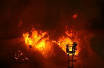 CHONGQING, CHINA - JULY 2: (CHINA OUT) Firemen put out a blaze during an anti-terror drill themed 'To Welcome Olympic Games,To Ensure the Security' at Datianwan Stadium on July 2, 2008 in Chongqing Municipality, China. China has launched a series of anti-