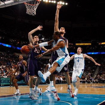 NEW ORLEANS - JANUARY 21:  Chris Paul #3 of the New Orleans Hornets passes the ball around Brook Lopez #11 of the New Jersey Nets on January 21, 2009 at the New Orleans Arena in New Orleans, Louisiana.  NOTE TO USER: User expressly acknowledges and agrees