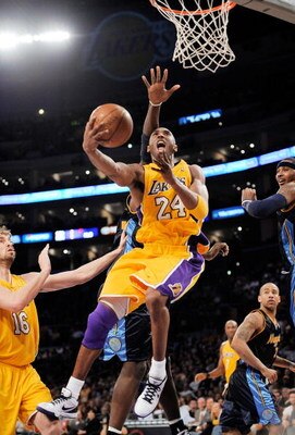 LOS ANGELES, CA - APRIL 9:  Kobe Bryant #24 of the Los Angeles Lakers scores as he drives to the basket against the Denver Nuggets at Staples Center April 9, 2009 in Los Angeles, California.  NOTE TO USER: User expressly acknowledges and agrees that, by d