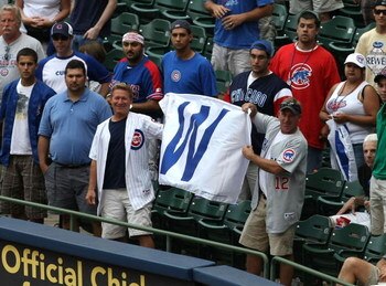 MILWAUKEE - JULY 31:  Fans of the Chicago Cubs hold up a win flag along the first baseline after the Cubs complete a four game sweep of the Milwaukee Brewers at Miller Park on July 31, 2008 in Milwaukee, Wisconsin. The Cubs defeated the Brewers 11-4.  (Ph