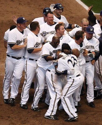 MILWAUKEE - APRIL 10: Members of the Milwaukee Brewers mob teammate Rickie Weeks #23 after Weeks scored the winning run in the bottom of the 9th inning against the Chicago Cubs during the Opening Day game on April 10, 2009 at Miller Park in Milwaukee, Wis