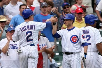 CHICAGO - JULY 19:  Ryan Theriot #2 and Mike Fontenot #17 of the Chicago Cubs celebrate after Theriot scored a run against the San Francisco Giants at Wrigley Field on July 19, 2007 in Chicago, Illinois. The Cubs won 9-8.  (Photo by Jamie Squire/Getty Ima