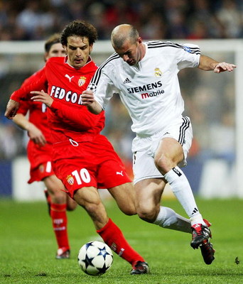 MADRID, SPAIN - MARCH 24: Zinedine Zidane of Real Madrid is tackled by Fernando Morientes of Monaco during the UEFA Champions League Quarter Final match between Real Madrid and Monaco at The Bernabeu on March 24, 2004 in Madrid, Spain. (Photo by Clive M