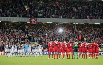 LIVERPOOL, UNITED KINGDOM - APRIL 5:  Juventus and Liverpool players stand with arms locked for one minutes silence commemorating the 20th anniversary of the Heysel Stadium disaster prior to the UEFA Champions League Quater-final, first leg match between 
