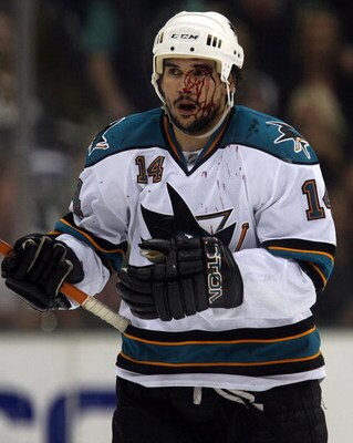 DALLAS - MAY 04:  Right wing Jonathan Cheechoo #14 of the San Jose Sharks skates to the bench after his face was cut against the Dallas Stars during game six of the Western Conference Semifinals of the 2008 NHL Stanley Cup Playoffs on May 4, 2008 at the A