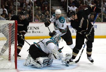 ANAHEIM, CA - MARCH 15:  Goaltender Evgeni Nabokov #20 of the San Jose Sharks and Corey Perry #10 of the Anaheim Ducks vie for the puck in the third period during their NHL game at Honda Center on March 15, 2009 in Anaheim, California.  (Photo by Victor D