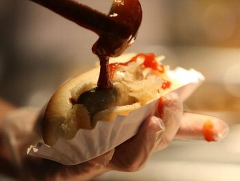 MILWAUKEE - APRIL 10: A worker prepares a bratwurst for a customer before the Opening Day game between the Milwaukee Brewers and the Chicago Cubs on April 10, 2009 at Miller Park in Milwaukee, Wisconsin. The Brewers defeated the Cubs 4-3. (Photo by Jonath